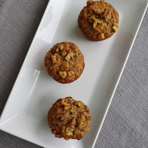 Three muffins on a white dish
