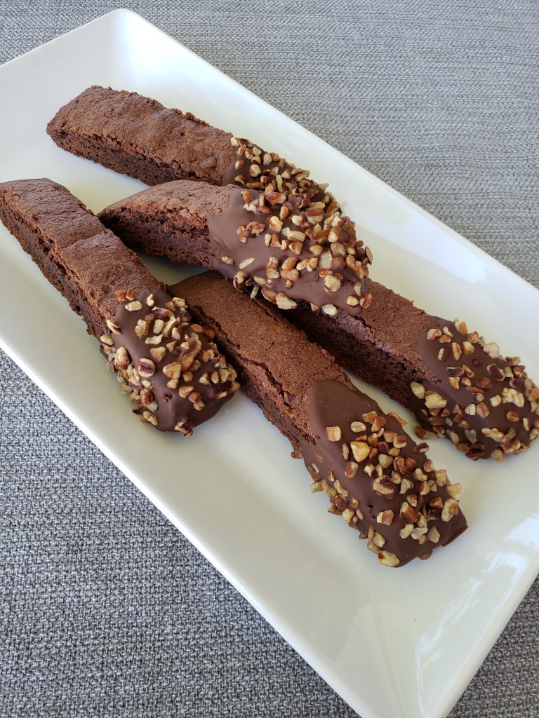 Chocolate biscotti dipped in chocolate and pecan bits